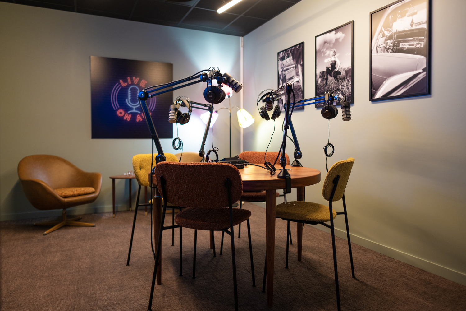 Podcast studio with microphones and table with chairs